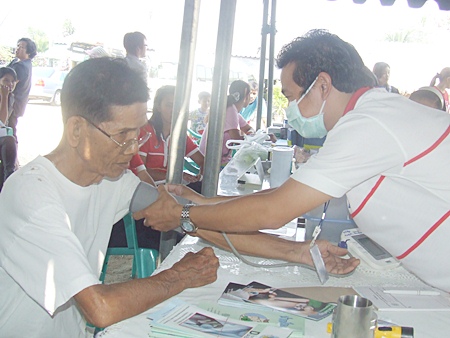 Tiang Ansam-ang (left) receives another checkup, his 5th, and said he is very happy with the mobile medical unit.